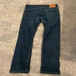 Dark Blue Straight Levi Jeans with Light Stitching and Subtle Fading